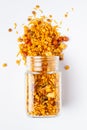 Hot spicy Nav Ratan snacks spilled out and in a glass jar, made with red chili, peanuts, corn flakes.