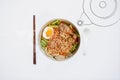 Hot and Spicy noodle in bowl and ingredients on isolated white background, Korea noodles with boil eggs in bowl with spoon and cho Royalty Free Stock Photo