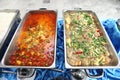 Hot Spicy Red Curry Chicken and Tofu Soup in stainless steel container ready for Buffet Catering for Group