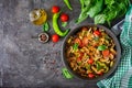 Hot spicy stew eggplant, sweet pepper, tomato, zucchini and mushrooms. Royalty Free Stock Photo