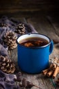 Hot spicy tea with anise and cinnamon in vintage blue enamel mug