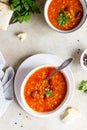 Hot and spicy, thick lentil and red bean soup with canned tomatoes and coriander. Concrete background. Top view