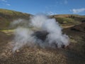 Hot spring with boiling water rising from rocks in Landmannalaugar colorful Rhyolit mountains on famous Laugavegur trek Royalty Free Stock Photo