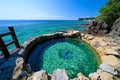 A hot spring by the ocean, where the warm water meets the cool waves lapping at the shore Royalty Free Stock Photo