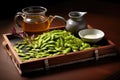 hot, steamed edamame arranged on rustic serving tray