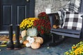 Hot Steaming Coffee Sitting on Chair on Front Porch Decorated for Autumn