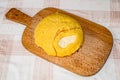 Hot steaming polenta with cottage cheese on a old wooden board on the table