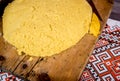 Hot steaming polenta on a old wooden board on the table