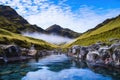 hot steamy spring nestled between rugged mountain