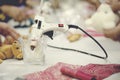 Hot stick glue gun on cup. red fabrick and doll on white table Royalty Free Stock Photo