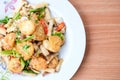 The hot stir fried tofu and pork and mushroom with black bean sauce serve on white dish set on brown table - homemade food concept Royalty Free Stock Photo