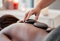 Hot stone massage, spa and hand of masseuse, holistic care and wellness with black woman and treatment. Health, peace of Royalty Free Stock Photo
