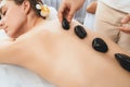 Hot stone massage at spa salon in luxury resort. Quiescent Royalty Free Stock Photo