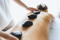 Hot stone massage at spa salon in luxury resort. Quiescent