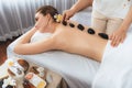 Hot stone massage at spa salon in luxury resort. Quiescent