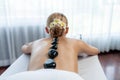 Hot stone massage at spa salon in luxury resort. Quiescent