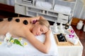 Hot stone massage at spa salon in luxury resort. Quiescent