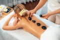 Hot stone massage at spa salon in luxury resort. Quiescent