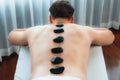 Hot stone massage at spa salon in luxury resort. Quiescent