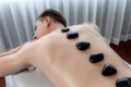 Hot stone massage at spa salon in luxury resort. Quiescent