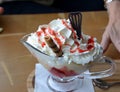 Hot strawberries and vanilla ice cream with whipped cream on a glass bowl. Royalty Free Stock Photo