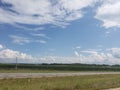 Hot summer day with white clouds sitting over the corn fields Royalty Free Stock Photo