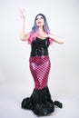 Gothic plus size adult mermaid on white studio background