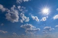 Sparkle sun on a blue cloudy sky Royalty Free Stock Photo