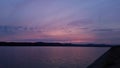 Hot sunset above the forest. Refelctions of red clouds in the water of the lake. bright colors at the end of a summer day