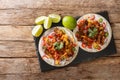 Hot tacos with grilled pork belly, seasonal vegetables, cheddar and lime close-up on a slate board. horizontal top view Royalty Free Stock Photo