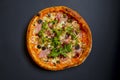 Hot tasty delicious rustic homemade american pizza over black background. Traditional Italian cuisine concept Royalty Free Stock Photo