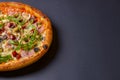 Hot tasty delicious rustic homemade american pizza over black background. Traditional Italian cuisine concept Royalty Free Stock Photo