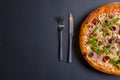 Hot tasty delicious rustic homemade american pizza over black background. Traditional Italian cuisine concept Royalty Free Stock Photo