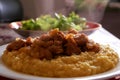 Hot tasty Pilaf (meat of a ram paella) in plate and green lettuce in table Royalty Free Stock Photo