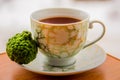 Hot tea with bergamot on wooden table in the cold.