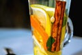 Hot tea with cinnamon bark, lemon and green leaves Royalty Free Stock Photo