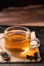 Hot tea in cup glass with dried tea leaves Royalty Free Stock Photo