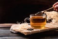 Hot tea in cup glass with dried tea leaves in spoon Royalty Free Stock Photo