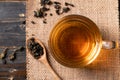 Hot tea in cup glass with dried tea leaves in spoon Royalty Free Stock Photo