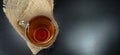 Hot tea cup glass on a winter day with burlap/hessian at a black background/ tea time! Royalty Free Stock Photo