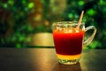 Hot tea glass with a mixture of sweetened condensed milk and tea Put on the table at night Green forest background and beautiful Royalty Free Stock Photo