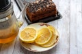 Hot tea in glass teapot and cup with spoon and steam on wooden table Royalty Free Stock Photo