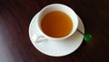 Hot tea leaves in white ceramic cup with beautiful cups put boiled water, hot tea leaves. Placed on a piece of chocolate-colored p Royalty Free Stock Photo