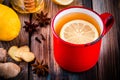 Hot tea with lemon in a rustic mug with honey