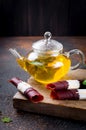 Hot tea with mint in a teapot and dry fruits leather roll Royalty Free Stock Photo