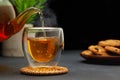 hot tea pouring from teapot into glass cup on table Royalty Free Stock Photo