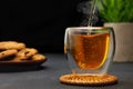 hot tea pouring from teapot into glass cup on table Royalty Free Stock Photo