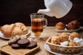 Hot tea put on table, drink breakfast in the morning day, breakfast with croissants and sweets on wooden table Royalty Free Stock Photo