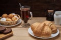 Hot tea put on table, drink breakfast in the morning day, breakfast with croissants and sweets on wooden table Royalty Free Stock Photo