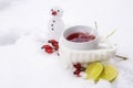 Hot tea with rose hips and lemons outside in the snow and a little snowman, vitamin winter drink against flu and common cold Royalty Free Stock Photo